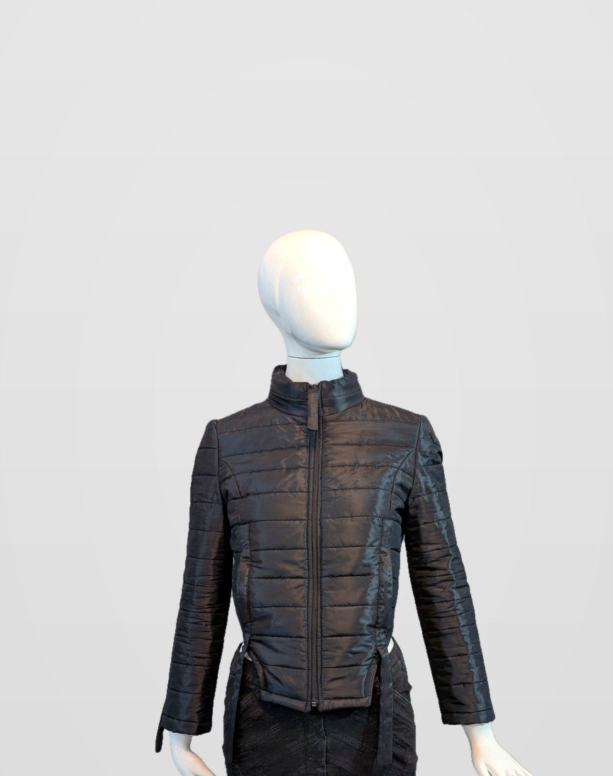Black Nova Puffer front view during construction on a mannequin, framed just below the jacket hem and side-strap ends