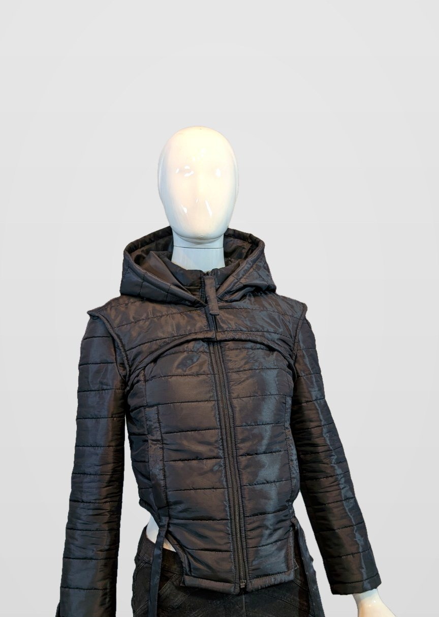 Black Nova Puffer with the hood raised on a mannequin, framed just below the jacket hem