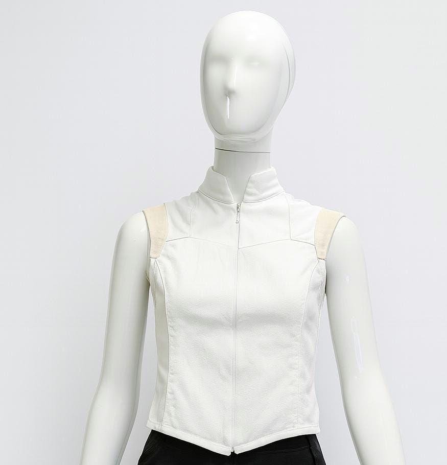 Photon Shell Top — white futuristic sleeveless top on a mannequin, framed just below the pointed top hem